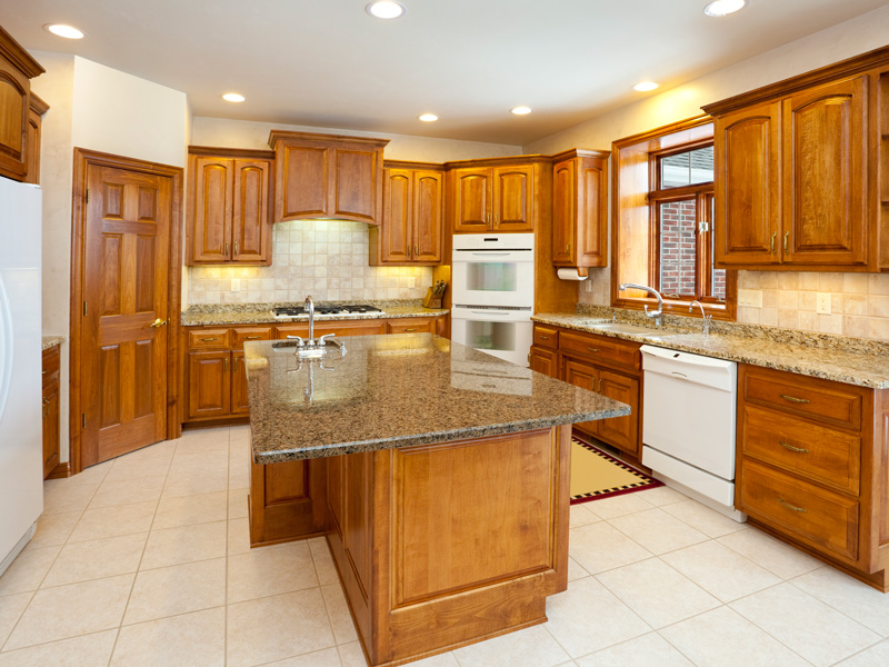 wood cabinets and granite countertops in a kitchen