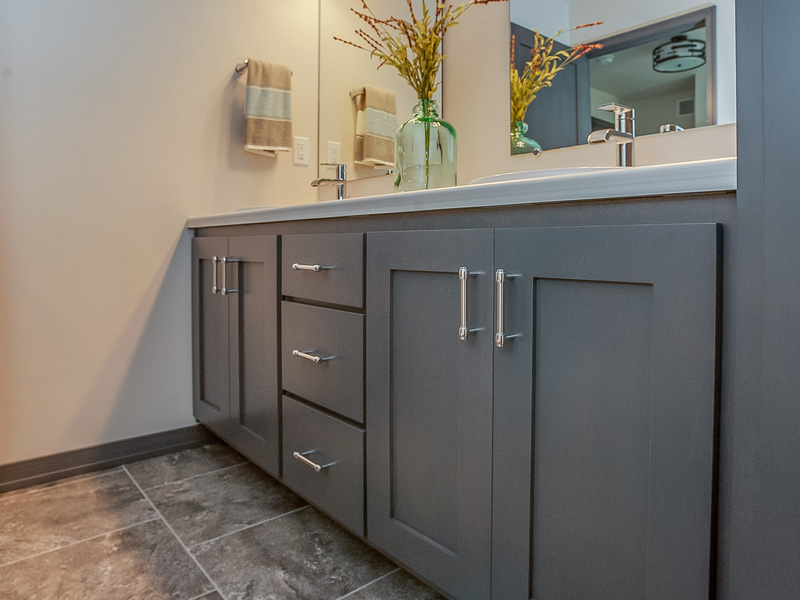 dark grey cabinets under a bathroom sink