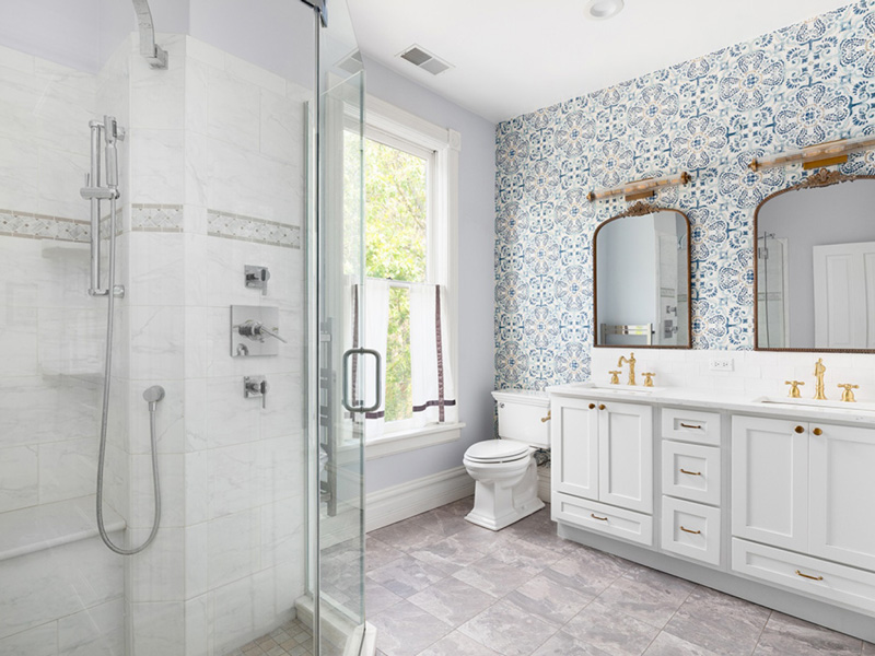 white cabinets and floral wallpaper in a bathroom